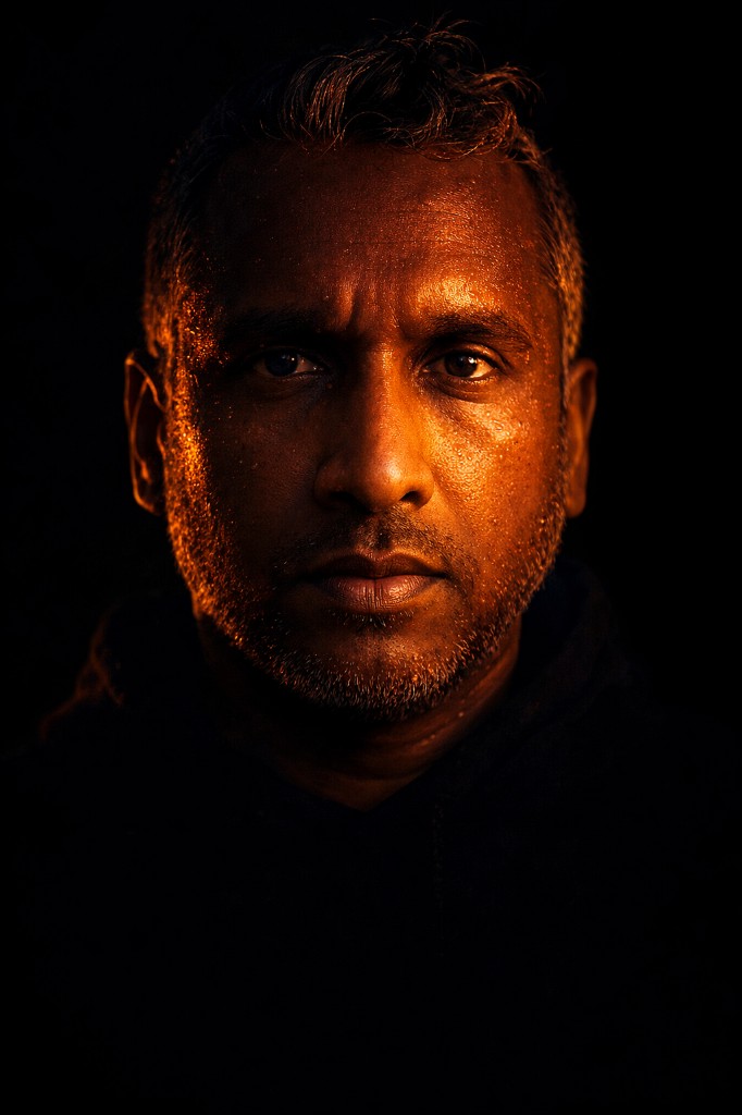 Shiren Mathai, dramatic lighting, serious expression